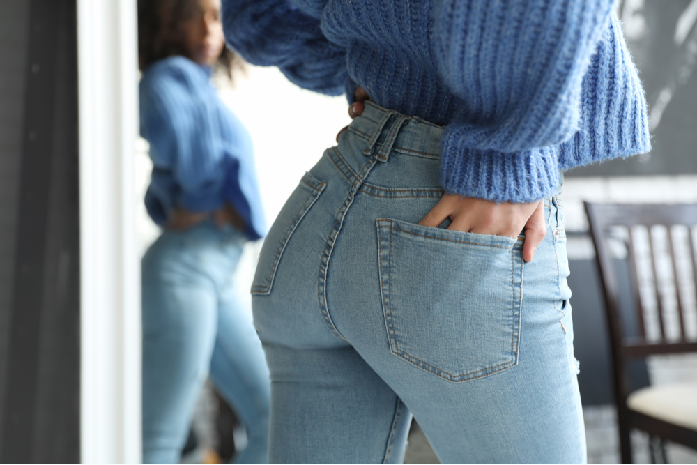 Woman wearing jeans near mirror